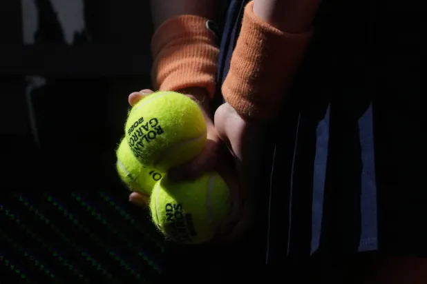 A ballgirl stands during the draw for the French Open tennis tournament, Thursday, May 21, 2026, at the Roland Garros stadium in Paris. (AP Photo/Thibault Camus)