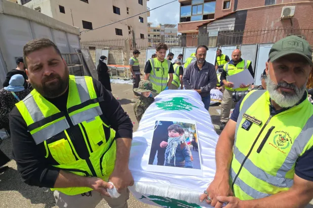 Officials carry the bodies of victims killed in the Israeli strike on the southern village of Deir Qanoun al-Nahr, outside Jabal Amel Hospital in the Tyre area of south Lebanon, before the bodies were transferred to their hometown for burial, as security conditions prevented families from holding the farewell ceremony in the village, on May 21, 2026. (Photo by KAWANT HAJU / AFP)