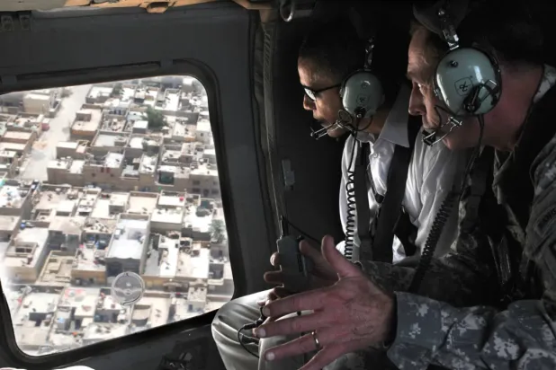A 2008 photo released by the Pentagon shows David Petraeus briefing Barack Obama, then a US senator, on a plan to secure Sadr City in eastern Baghdad during an aerial tour over the area.