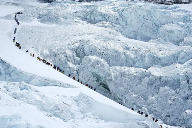 Climbers walk in a long queue as they head to summit Mount Everest in the Solukhumbu district, also known as the Everest region, Nepal, May 18, 2026. REUTERS/Purnima Shrestha
