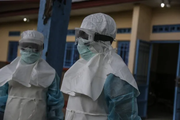 Medical staff wearing personal protective equipment (PPE) are seen at the hospital in Rwampara on May 21, 2026. (AFP)