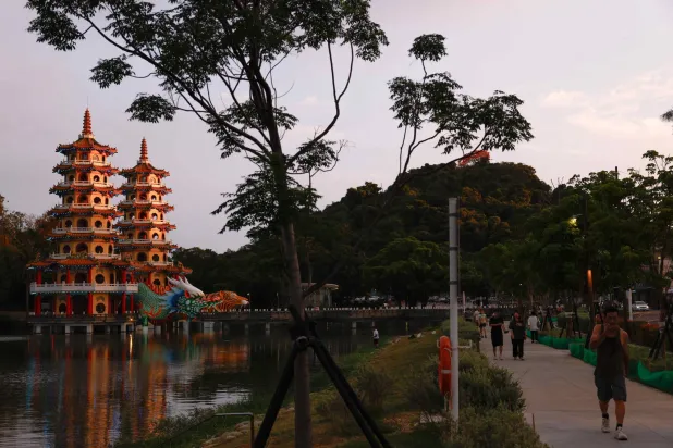 People walk past the Dragon and Tiger Pagodas at Lotus Pond in Kaohsiung, Taiwan, May 15, 2026. REUTERS/Ann Wang