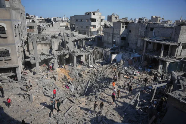 Palestinians inspect the rubble of a building that was destroyed by an Israeli airstrike at al-Bureij refugee camp in the central Gaza Strip, Saturday, May 23, 2026. (AP Photo/Abdel Kareem Hana)