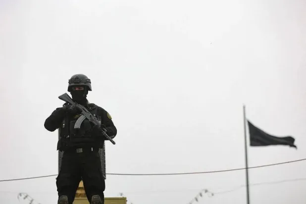 A security personnel stands guard as Iranians take part in a protest marking the annual al-Quds Day (Jerusalem Day) on the last Friday of the holy month of Ramadan, amid the US-Israeli conflict with Iran, in Tehran, Iran, March 13, 2026. Majid Asgaripour/WANA (West Asia News Agency) via Reuters
