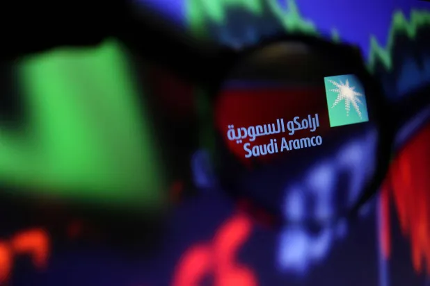 FILE PHOTO: Saudi Aramco logo and stock graph are seen through a magnifier displayed in this illustration taken September 4, 2022. REUTERS/Dado Ruvic/Illustration/File Photo