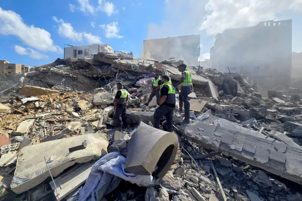 Lebanese civil defense workers search through the rubble of a building following an Israeli strike at dawn in the southern Lebanese area of al-Hosh, near the coastal city of Tyre on May 26, 2026. (Photo by AFP)