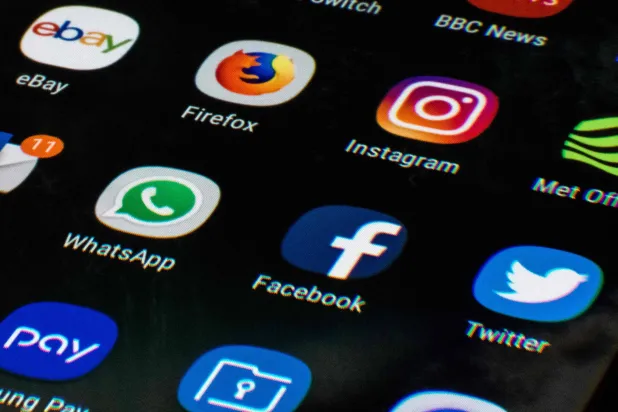 (FILES) This photo illustration shows a mobile phone screen displaying the icons for the social networking apps Facebook, Twitter and Instagram, taken in Manchester on March 22, 2018. (Photo by Oli SCARFF / AFP)