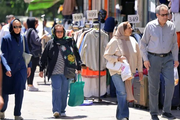 People walk past shops along Valiasr Square in Tehran on May 26, 2026. (AFP)