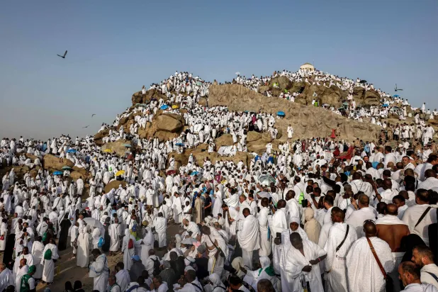 Muslim pilgrims pray on Saudi Arabia's Mount Arafat, also known as Jabal al-Rahma or Mount of Mercy, during the climax of the Hajj pilgrimage early on May 26, 2026. (AFP)