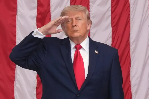 President Donald Trump salutes during the playing of taps at the 158th National Memorial Day Observance coinciding with the nation's 250th anniversary, at the Memorial Amphitheater in Arlington National Cemetery, Monday, May 25, 2026, in Arlington, Va. (AP) 