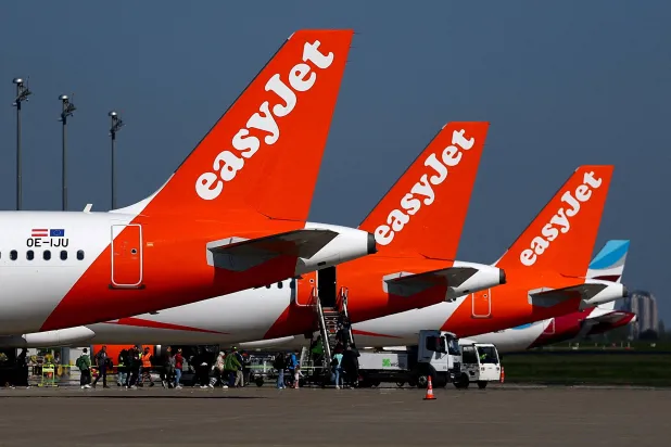 FILE PHOTO: Passengers board an easyJet aircraft at the Berlin Brandenburg Airport in Schoenefeld, Germany, April 21, 2026. REUTERS/Lisi Niesner/File Photo