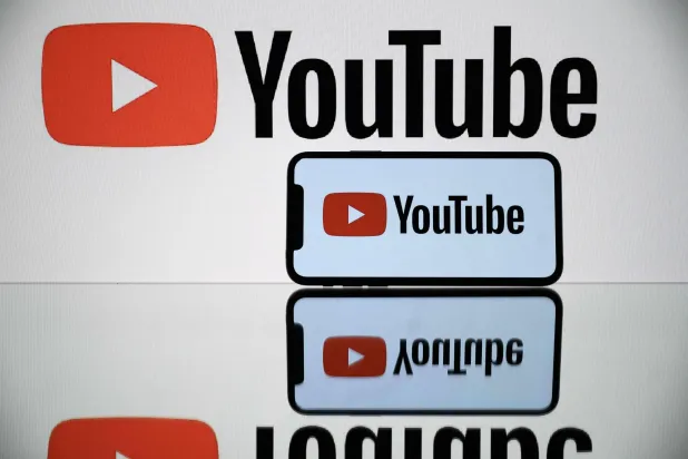  A picture taken on October 5, 2021 in Toulouse shows the logo of YouTube social media displayed by a by a tablet and a smartphone. (Photo by Lionel BONAVENTURE / AFP)
