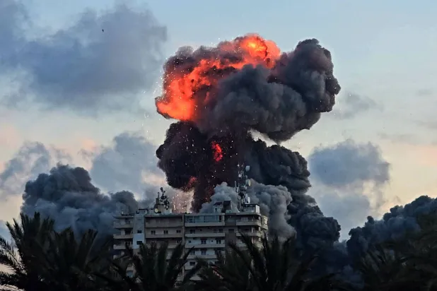 A fireball and smoke erupt from a building following an Israeli strike in Tyre, southern Lebanon, on May 28, 2026. (AFP)