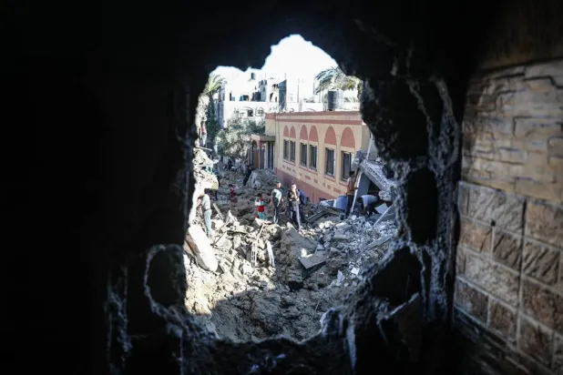  29 May 2026, Palestinian Territories, Dair al-Balah: Palestinians inspect the rubble of a building destroyed in an Israeli airstrike in Deir al-Balah, central Gaza Strip. (dpa)