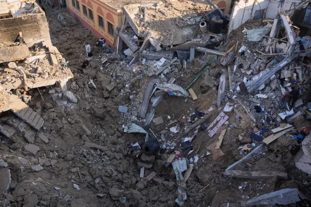  Palestinian women inspect the rubble of a building destroyed in an Israeli airstrike in Deir al-Balah, in the central Gaza Strip, Friday, May 29, 2026. (AP)