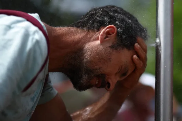  Tennis - French Open - Roland Garros, Paris, France - May 29, 2026 A spectator uses a tap outside the courts during the matches. (Reuters)