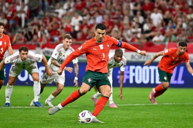 Portugal's Cristiano Ronaldo scores his side's second goal from the penalty spot during a World Cup 2026 group F qualifying match between Hungary and Portugal at the Puskas Arena in Budapest, Tuesday, Sept. 9, 2025. (AP) 