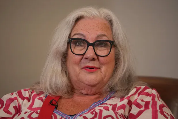 Sue Tilley, a model for British painter Lucian Freud, speaks in front of Freud's painting of her, titled "Sleeping by the Lion Carpet" during an interview in Sotheby's auction house in London, Thursday, May 28, 2026. (AP)