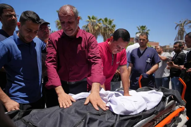  Mourners take the last look at the body of Jamal Abu Aoun, who was killed in an Israeli airstrike, during his funeral at al-Aqsa Hospital in Deir al-Balah, central Gaza Strip, Saturday May 30, 2026. (AP) 