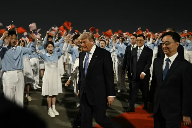 US President Donald Trump (C) is escorted by China's Vice President Han Zheng (R) upon his arrival at Beijing Capital Airport in Beijing on May 13, 2026. (AFP)