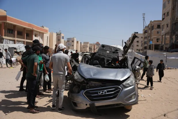Palestinians inspect a vehicle struck by an Israeli airstrike in Khan Younis, southern Gaza Strip, Sunday, May 10, 2026. (AP) 