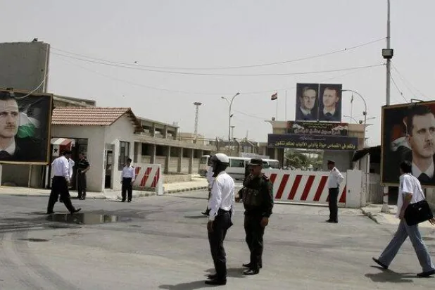 Police stand at the gate of Damascus Central Prison in the Adra area near the Syrian capital of Damascus in this May 28, 2010 file photo. REUTERS/Khaled al-Hariri/Files/File 