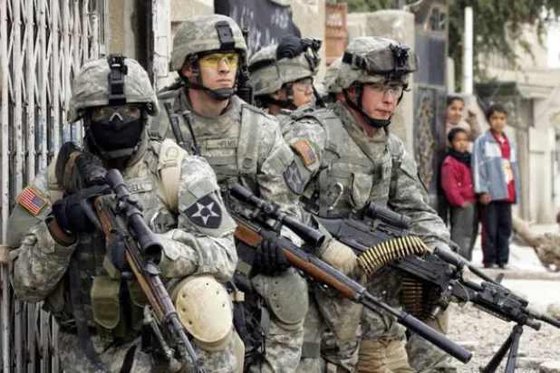 US Army soldiers from the 5-20 Infantry Division take up positions to provide cover for fellow soldiers as part of the launch of Operation Arrowhead Strike Six in the Shaab neighborhood of northern Baghdad, 06 February 2007. (AFP)