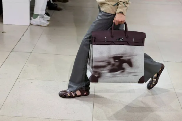 A model presents a creation by designer Veronique Nichanian as part of her Menswear Spring/Summer 2026 collection show for the fashion house Hermes during Men's Fashion Week in Paris, France, June 28, 2025. (Reuters) 