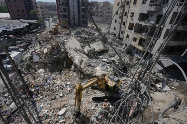  Rescue workers use excavators, as they search for victims under the rubble of a building that was hit Monday in an Israeli airstrike in the southern port city of Tyre, Lebanon, Tuesday, June 2, 2026. (AP) 