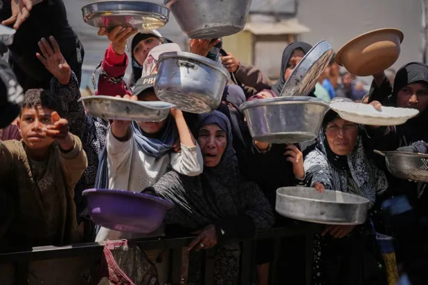  Palestinians wait to receive donated food at a distribution center in Khan Younis, Gaza Strip, Wednesday, May 27, 2026. (AP) 