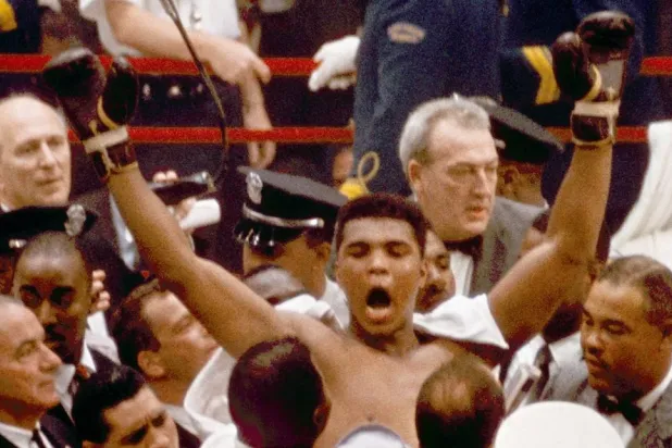 In this Feb. 25, 1964, file photo, Muhammad Ali, or Cassius Clay at the time, strikes a familiar pose as he shouts "I am the greatest," as he leaves the ring, arms raised, following his defeat of former heavyweight boxing champion Sonny Liston, in Miami Beach, Fla. (AP file) 