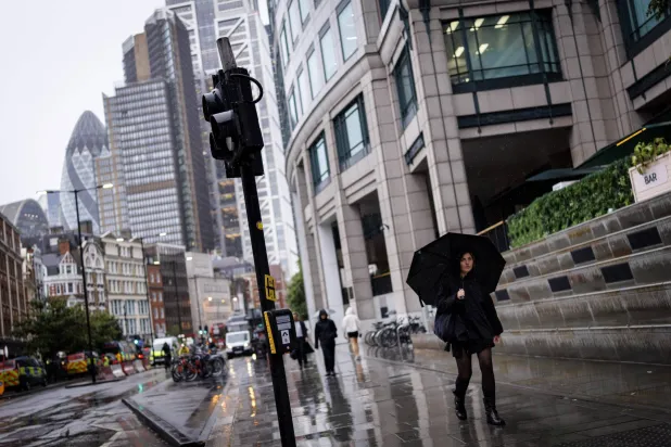 A person walks with an umbrella during the rain in the City of London financial district in London, Britain, 02 June 2026. EPA/TOLGA AKMEN