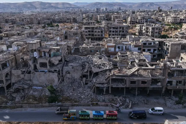 28 May 2026, Syria, Jobar: Syrians play in an Eid al-Adha amusement park in a devastated area amid the completely destroyed Jobar neighborhood on the outskirts of Damascus during the second day of the Muslim Feast of Sacrifice, Eid al-Adha. Photo: Moawia Atrash/dpa

