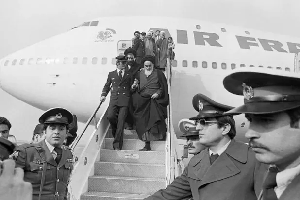 (FILES) Photo taken 01 February 1979 at Tehran airport of Ruhollah Khomeini (C) leaving the Air France Boeing 747 jumbo that flew him back from exile in France to Tehran. Getty Images