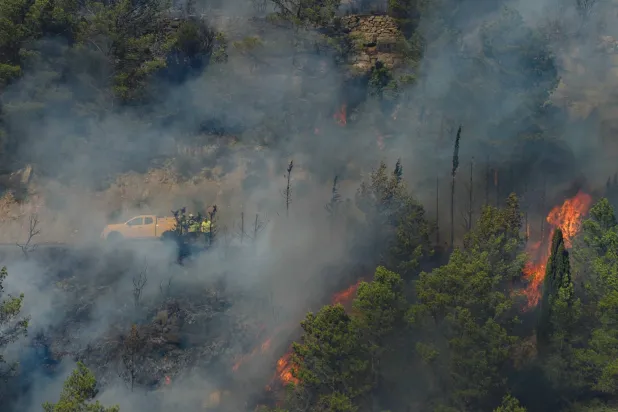 (FILES) In this photo taken on August 5, 2025, a DFCI wildfire defense vehicle from the National Forestry Office (ONF) is seen after the start of the Corbieres wildfire in Ribaute, southwest France. (Photo by Idriss Bigou-Gilles / AFP)