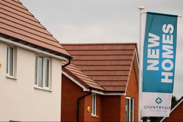 A banner advertising new houses for sale a seen on a new housing development under construction in Partington, Britain June 1, 2023. REUTERS/Phil Noble