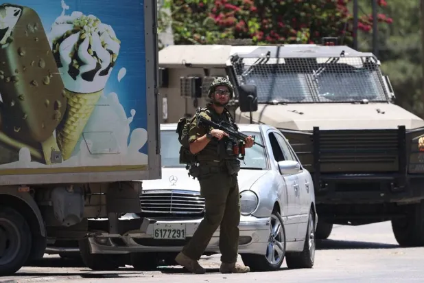 An Israeli soldier takes position during a raid in the West Bank city of Nablus, 01 June 2026. (EPA)