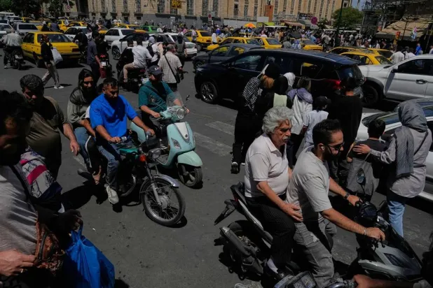  Pedestrians and vehicles cross an intersection around Tehran's historic Grand Bazaar, Iran, Monday, June 1, 2026. (AP) 
