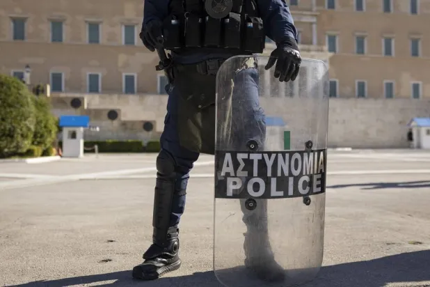 20 November 2024, Greece, Athens: A Greek police officer stands guard during a security deployment. (dpa)