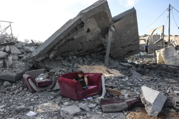 A boy sits on an armchair amid the rubble of a building near the site of an Israeli airstrike in Khan Yunis, southern Gaza Strip, on June 7, 2026. (Photo by Bashar Taleb / AFP)
