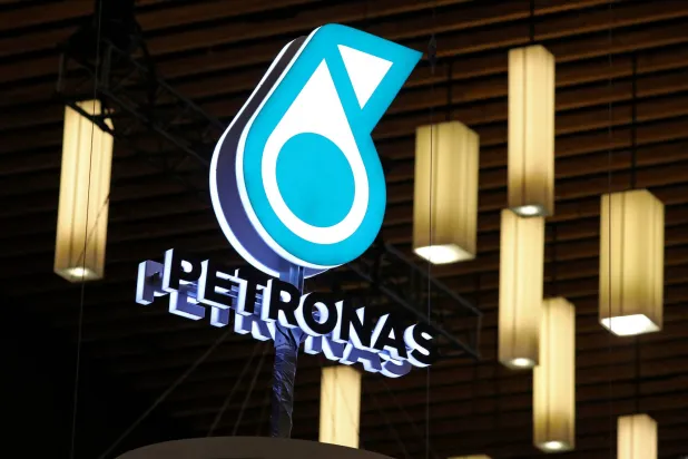 FILE PHOTO: The logo of Malaysian energy group National Petroleum Limited, commonly known as PETRONAS, is displayed at their booth during the LNG 2023 energy trade show in Vancouver, British Columbia, Canada, July 12, 2023. REUTERS/Chris Helgren/File Photo