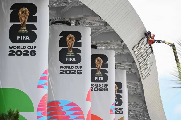 Workers are seen on a crane at Los Angeles Stadium (temporarily renamed from SoFi Stadium) ahead of the 2026 FIFA World Cup in Los Angeles on June 7, 2026. (AFP)