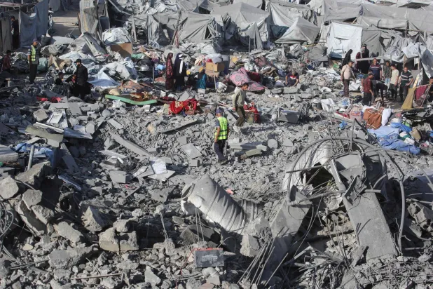 Palestinians assess damage at the site of an Israeli airstrike in Khan Younis, southern Gaza Strip, on June 7, 2026. (AFP)