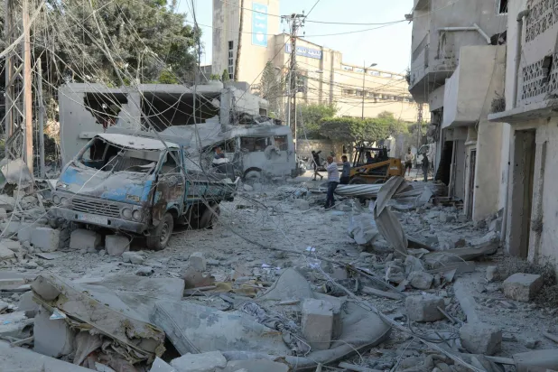 Workers clean the debris following Israeli airstrikes that hit the previous day, near the archaeological site of the Roman hippodrome in the southern Lebanese city of Tyre on June 8, 2026. (AFP)