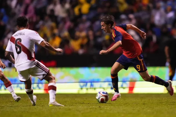 Spain's Gavi, right, and Peru's Jesus Pretell compete for the ball during an international soccer match in Puebla, Mexico, Monday, June 8, 2026. (AP Photo/Moises Castillo)
