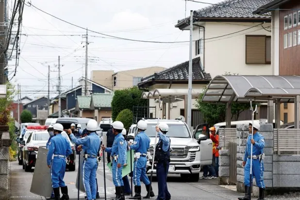  Police officers with shields and sticks search for a bear at a residential area after a black bear was spotted in Utsunomiya, Tochigi Prefecture, Japan, June 9, 2026. (Reuters)