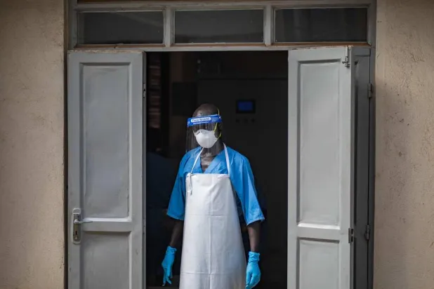 A health worker wearing a face mask as part of his personal protection equipment (PPE) looks on at the Mulago National Referral Hospital isolation unit in Kampala, Uganda, on July 8, 2026. (AFP)