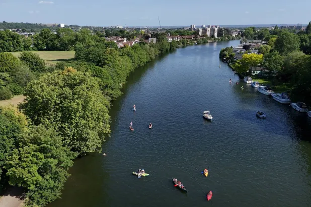 FILE PHOTO: A drone view shows people using kayaks and paddle boards in the River Thames at Teddington Lock, London’s first official river bathing water site, as temperatures climb over the bank holiday weekend due to a heat dome spreading across the region, in London, Britain, May 24, 2026. REUTERS/Isabel Infantes/File Photo