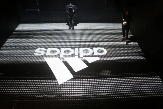 FILE PHOTO: An Adidas logo is seen at the new Futurecraft shoe unveiling event in New York City, New York, US April 6, 2017. REUTERS/Joe Penney/File Photo 