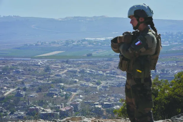 A French peacekeeper with the UN Interim Force in Lebanon (UNIFIL) stands on a hill overlooking Kfarkela, a Lebanese border village near Israel in southern Lebanon, on August 20, 2025. (AP)